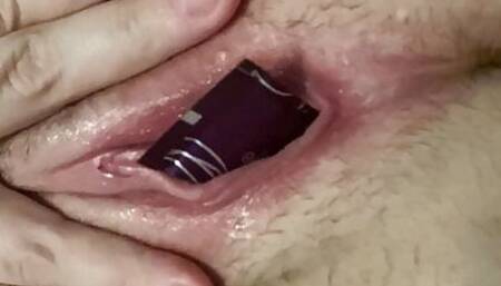 The hairy bitch turns herself with a tube.