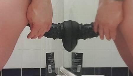 Carl cagedwarrior takes huge BBC dildo in hotel bathroom with mirror reflection