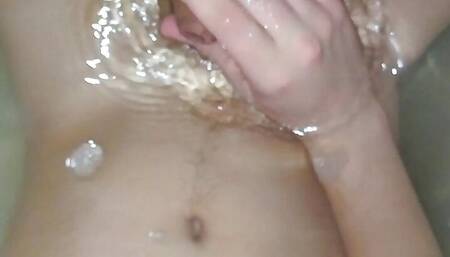 The guy jerks off a small dick and cums in the bathroom under water