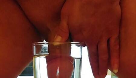 Chubby guy cumming in a glass of water