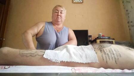 She massages my legs and jerks off my cock