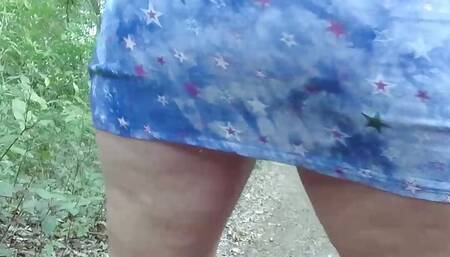 Walking and pissing in short dress outdoors