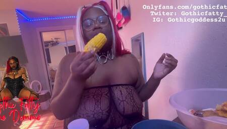 Ebony BBW stuffs her face while she is topless