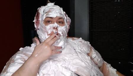 I lather myself down with shaving cream, covering my face, hair and tits