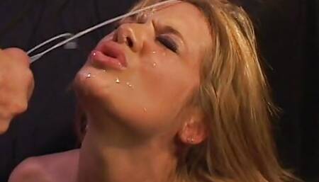 Alluring blonde gets cum on her face after milking a cum shooter