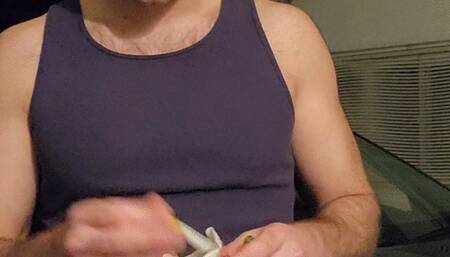 Hot guy smoking a cigarette in a tank top and popping balloons