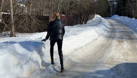 girl walks through the snowdrifts in high-heeled boots and falls deep into the snow