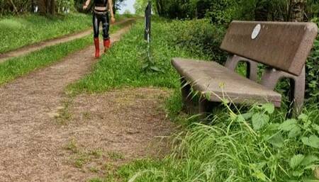 Hot Girl with red Hunter and Latexleggings at the Forrest with Kneeorthesis