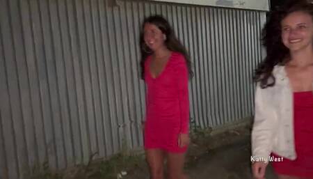 Two girls pissing in public near the car