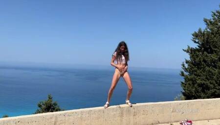 Shameless girl pissing standing on the background of the sea