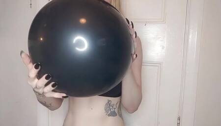 Blowing up large shiny balloon