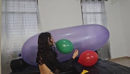 Marianna tries to pop balloons on top of her large GL 1200 balloon