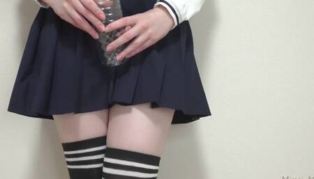 Cute Japanese schoolgirl tries to pee in a plastic bottle
