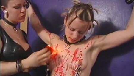 Dominatrix pours hot wax over her blonde slut