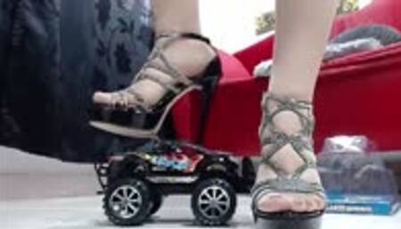 crushing a nice black monster Truck in nylons and heels