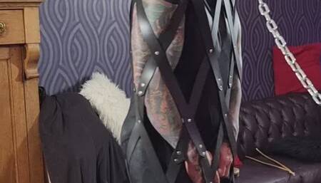 Hubby restrained in a leather cage