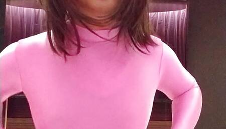 A cross-dressing boy masturbates wearing pink full-body tights up to his head.