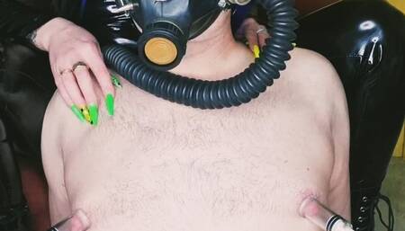 Slave in a gas mask. Fetish. Pumping male nipples, playing with nipples.