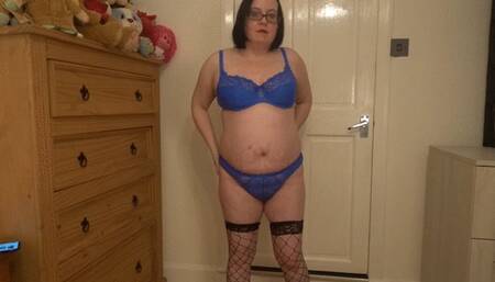 Striptease in blue panties and bra with stockings