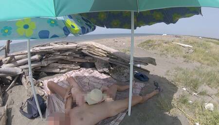 On a nudist beach in Tenerife, the stepdaughter jerks off her stepfather's cock without shame