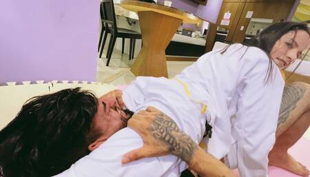 Sexy girl using judogi attacks a brazilian muscular stud in mixed wrestling and headscissors