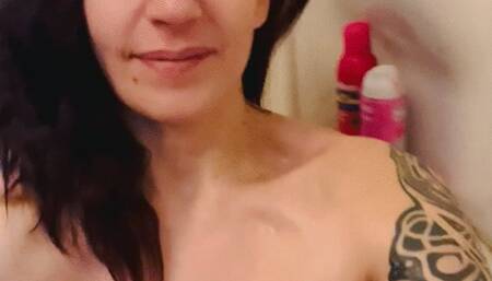 Sweaty in a bath, Nefariess plays with and licks her lactating breasts