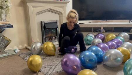 Chrome balloons sit popping