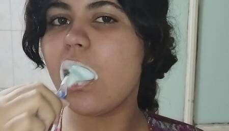 Fat brunette brushing her teeth