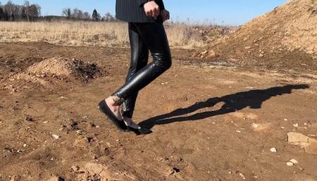 A girl in ballet flats walks on slippery and thick mud, ballet flats slide, and mud is poured into ballet flats