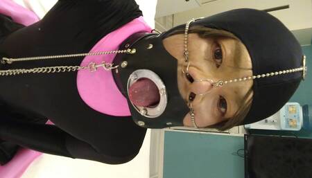 A cross-dressing boy turned into a female pig with pink full-body tights and a nose hook, and was further domesticated with a collar and gag shackles.