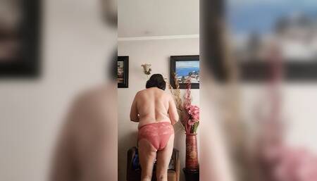 in underwear tidying up and the neighbor watching