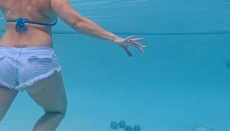 Carissa working out with weights in the pool wearing booty shorts