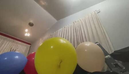 Akin blows balloon on the couch