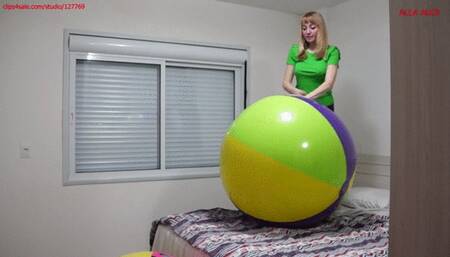 Alla deflates two large beach balls and happily jumps on them