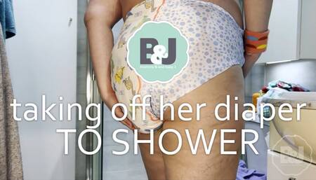 Taking off her diaper to shower