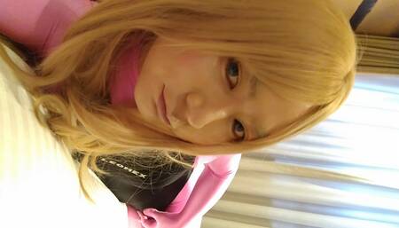 A blonde cross-dressing boy masturbated perverted over pink full-body tights wearing a swimsuit and gloves.
