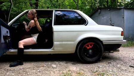 Anet is having fun with her neighbor's old BMW while he left it unattended