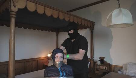 Rachel Adams bound, pantygagged and pantyhooded in shiny nylon Rainwear