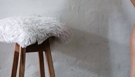 A lady in very high heels and a dress crosses her legs and leaves them dangling from her feet (2)