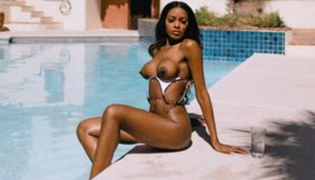 Petite ebony flaunts big boobs in a pool