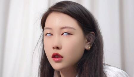 Model with white contact lenses touches something on the table with her feet Guess wrong I can play with her feet