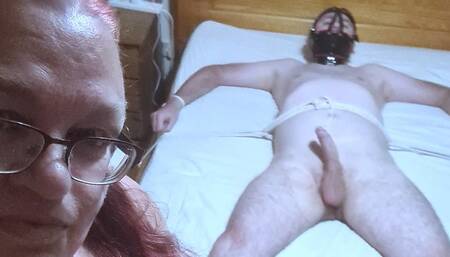 Handjob and cbt used on a naked man spreadeagled on bed