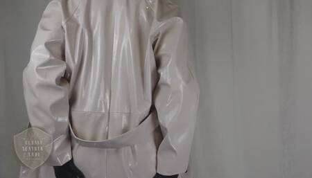 Classy Leather Lady poses in PVC coat, flexes with cane, gives instructions