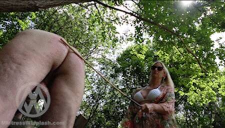 Nikki Whiplash gives a hard 120-stroke cold caning outside in the garden WL1786