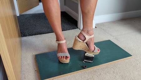 Nikkichick crushes a 1980's Dodge police car in big wedges with painted toe nails toy car crush high left view