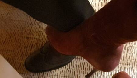 Teasing in red suede boots under the table