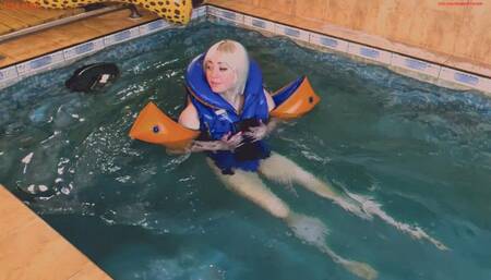 Alla wears a rare Snorke Pro inflatable vest and inflatable armbands while swimming in the pool