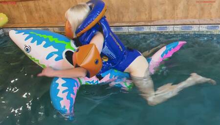 Alla hotly rubs herself astride a rare inflatable shark in a pool and wears a rare inflatable Snorkel Pro vest