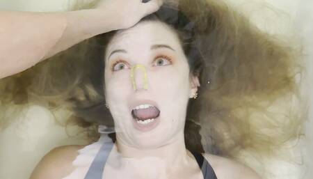 Milana is bound and held by hair underwater