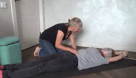 Mary squirms cries and struggles against the tickling BB